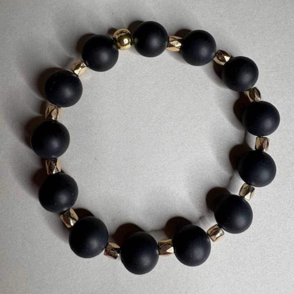 bold and modern bracelet with matte black round beads and gold spacers
